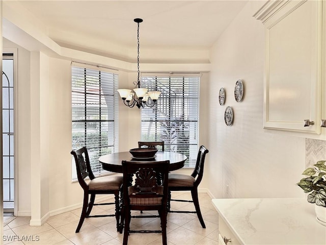 dining space with light tile patterned floors and a notable chandelier