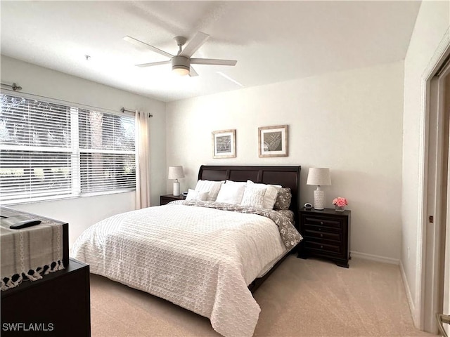 bedroom with ceiling fan and light colored carpet