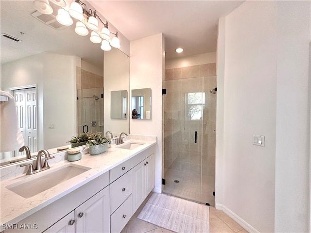 bathroom featuring tile patterned flooring, vanity, and an enclosed shower