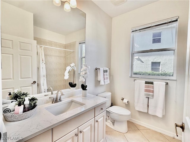 bathroom featuring tile patterned flooring, vanity, plenty of natural light, and curtained shower