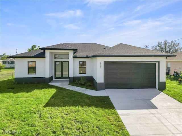 prairie-style home featuring a front lawn, an attached garage, and stucco siding