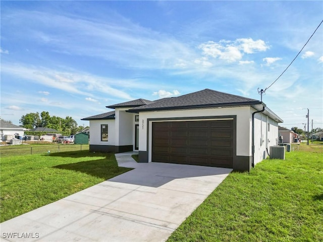 view of front of property with a garage, central AC, fence, stucco siding, and a front lawn