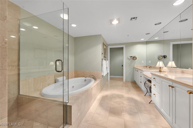 bathroom with plus walk in shower, vanity, and tile patterned floors