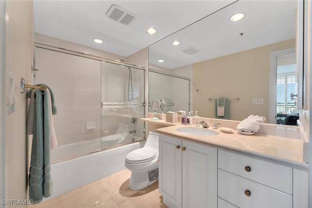 full bathroom featuring tile patterned flooring, combined bath / shower with glass door, toilet, and vanity