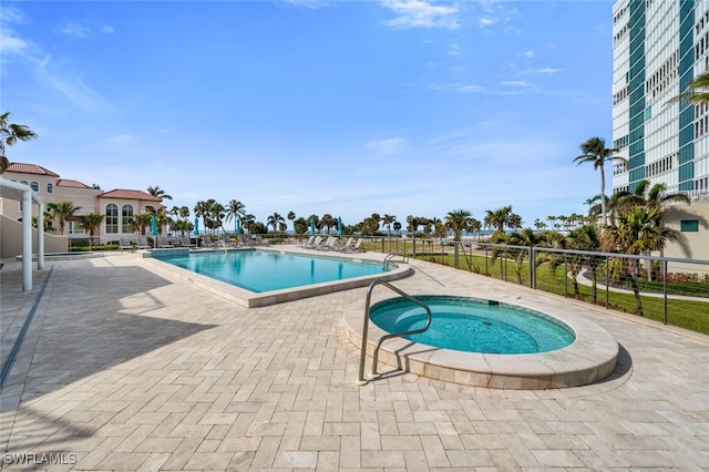 view of swimming pool featuring a community hot tub and a patio