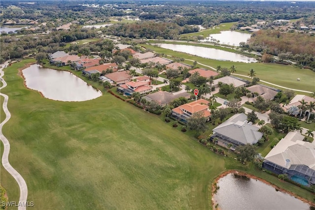 aerial view featuring golf course view, a water view, and a residential view