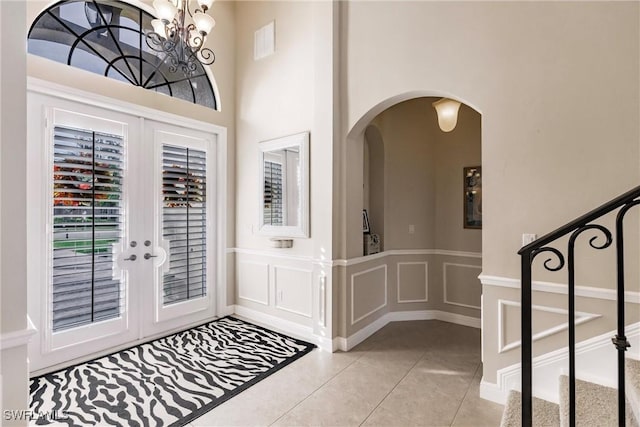 tiled foyer entrance featuring french doors