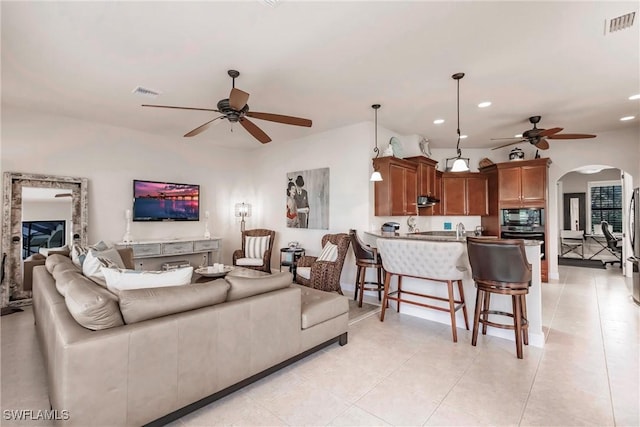 tiled living room featuring ceiling fan