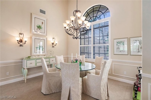 tiled dining area with plenty of natural light and a chandelier