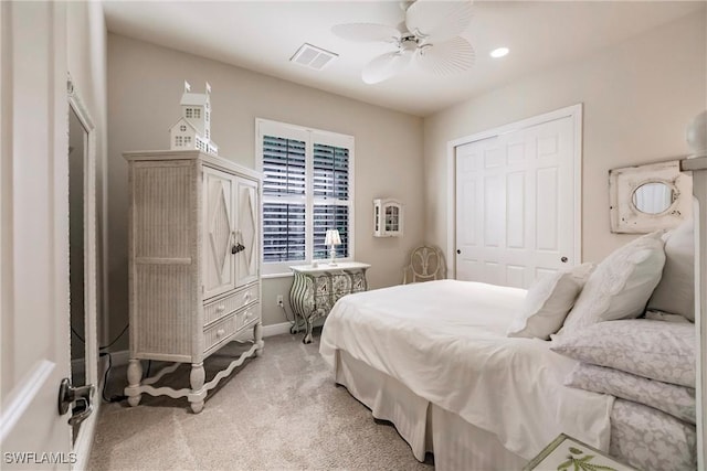 carpeted bedroom with a closet and ceiling fan