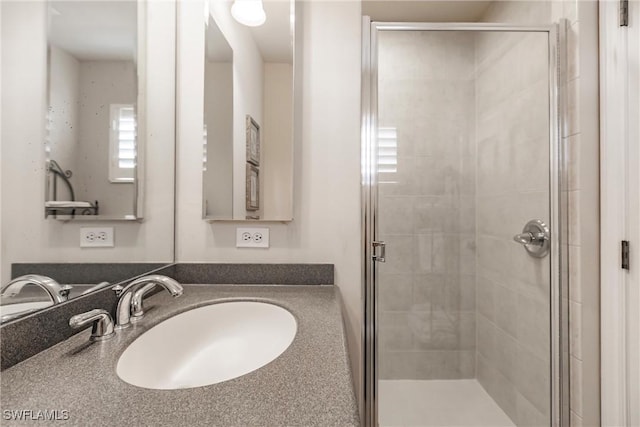 bathroom with sink and an enclosed shower