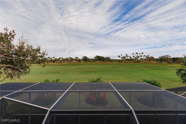 view of tennis court featuring a yard