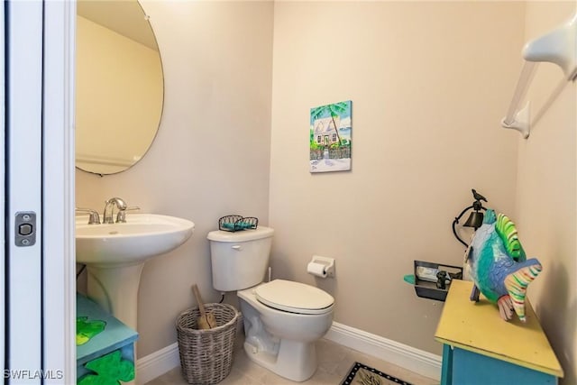 bathroom featuring tile patterned flooring and toilet