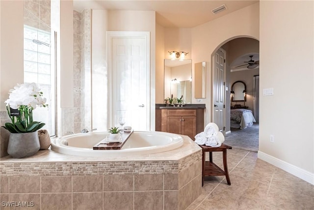 bathroom with visible vents, ensuite bathroom, vanity, tile patterned flooring, and a bath