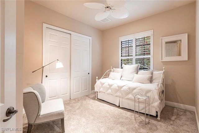 carpeted bedroom featuring a ceiling fan, baseboards, and a closet