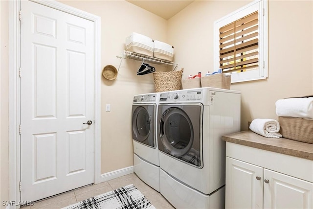 washroom with light tile patterned floors, independent washer and dryer, and baseboards