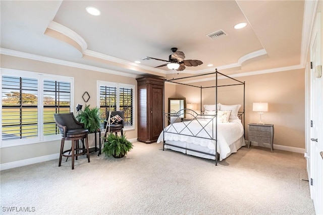 bedroom with baseboards, a tray ceiling, visible vents, and light colored carpet