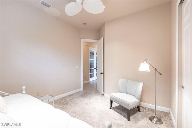 bedroom featuring light carpet, baseboards, visible vents, and a ceiling fan