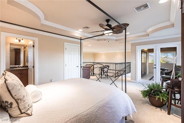 bedroom with light colored carpet, a raised ceiling, visible vents, and access to outside