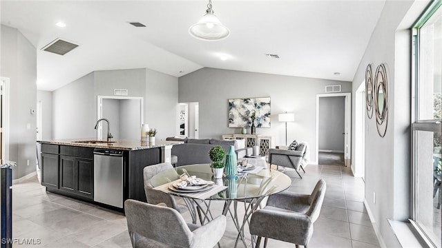 dining room with light tile patterned floors, lofted ceiling, and sink