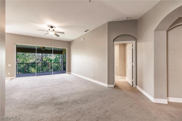 carpeted empty room featuring ceiling fan