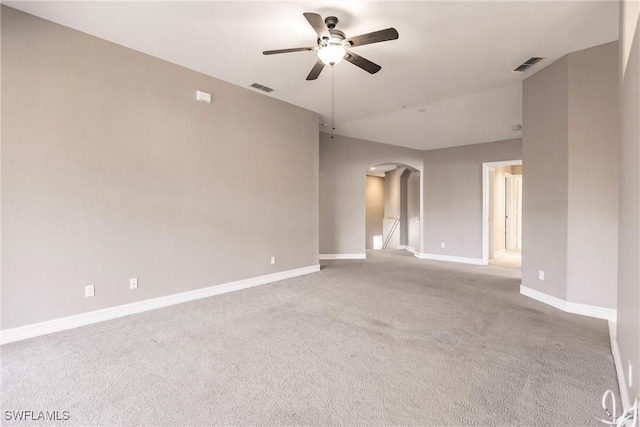 empty room featuring light colored carpet and ceiling fan