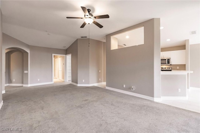 unfurnished living room featuring light colored carpet, ceiling fan, and lofted ceiling