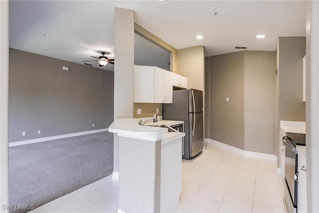 kitchen featuring white cabinetry, ceiling fan, stainless steel appliances, kitchen peninsula, and light carpet