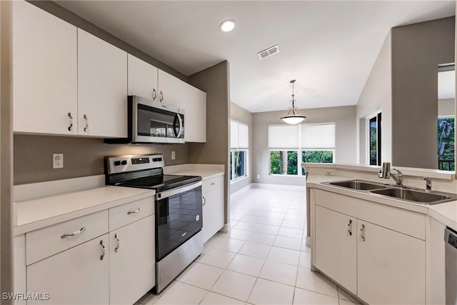 kitchen featuring stainless steel appliances, sink, pendant lighting, white cabinets, and lofted ceiling