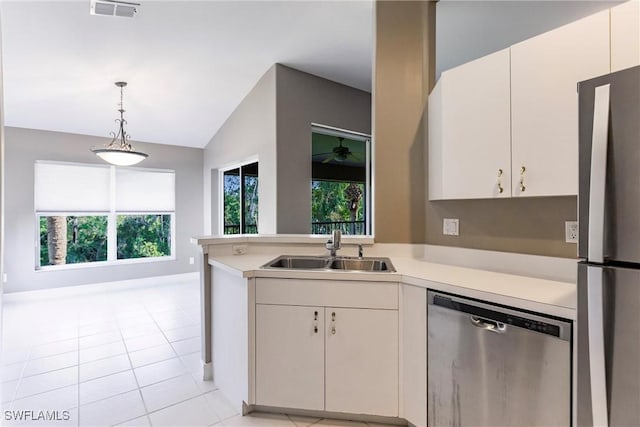 kitchen featuring lofted ceiling, sink, hanging light fixtures, white cabinetry, and stainless steel appliances