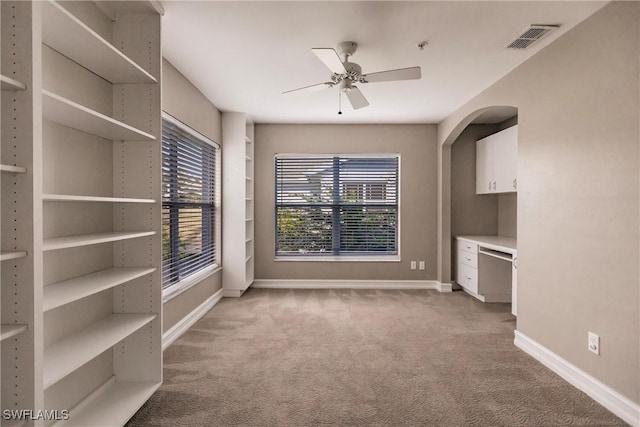 spare room with light colored carpet and ceiling fan