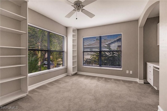 spare room with light colored carpet and ceiling fan