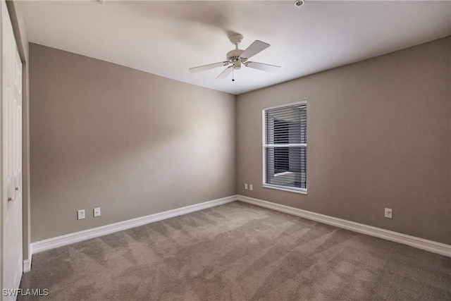 carpeted spare room with ceiling fan