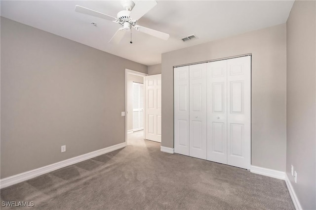 unfurnished bedroom with ceiling fan, carpet floors, and a closet