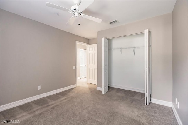 unfurnished bedroom featuring carpet, ceiling fan, and a closet