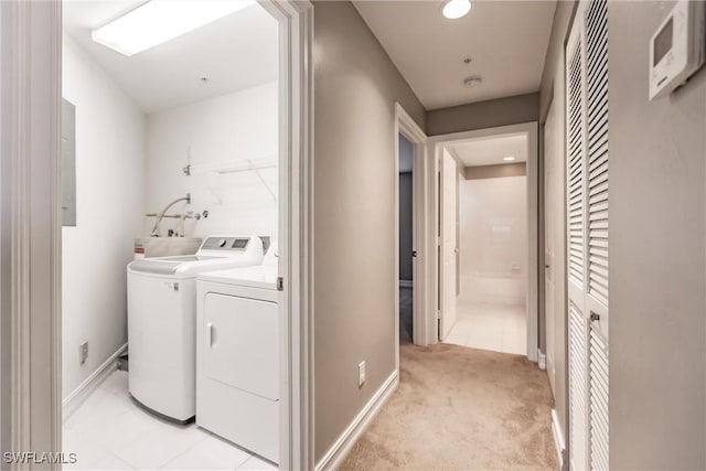 washroom featuring light colored carpet, electric panel, and washing machine and clothes dryer