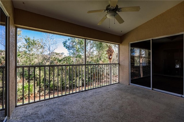 unfurnished sunroom with ceiling fan and lofted ceiling