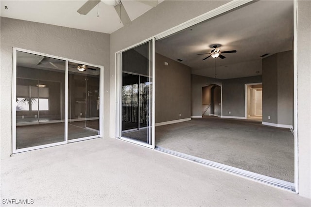 interior space with ceiling fan