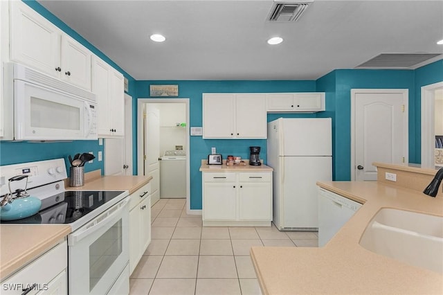 kitchen featuring white cabinetry, white appliances, sink, and washer / clothes dryer