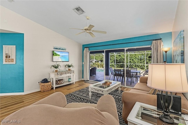 living room featuring hardwood / wood-style flooring, ceiling fan, and lofted ceiling