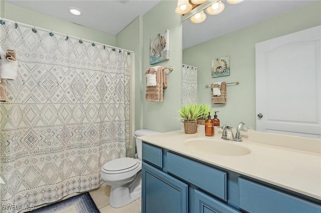 bathroom with toilet, vanity, and tile patterned floors