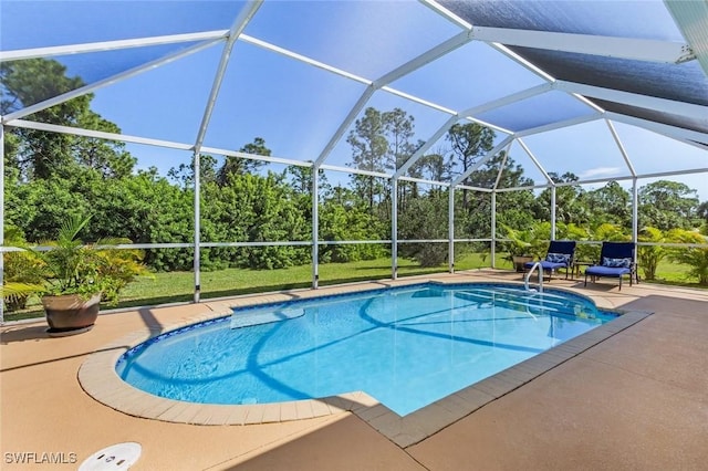 view of swimming pool with glass enclosure and a patio area