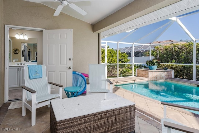 view of swimming pool with a patio, ceiling fan, and a lanai