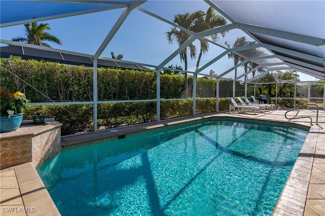 view of swimming pool with a lanai and a patio