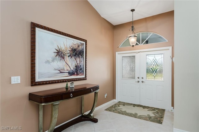 foyer featuring light tile patterned floors and french doors