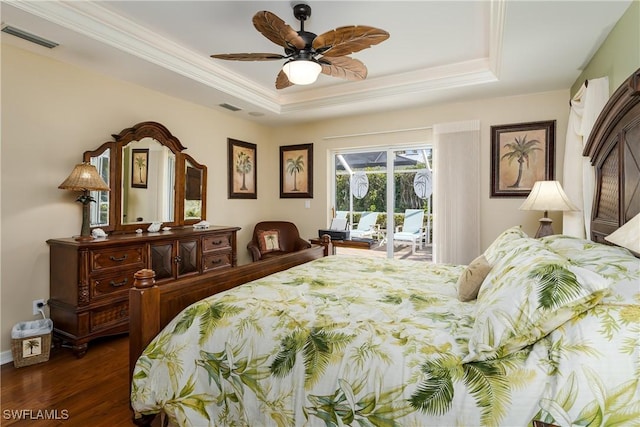 bedroom featuring dark wood-type flooring, access to outside, a raised ceiling, ceiling fan, and ornamental molding