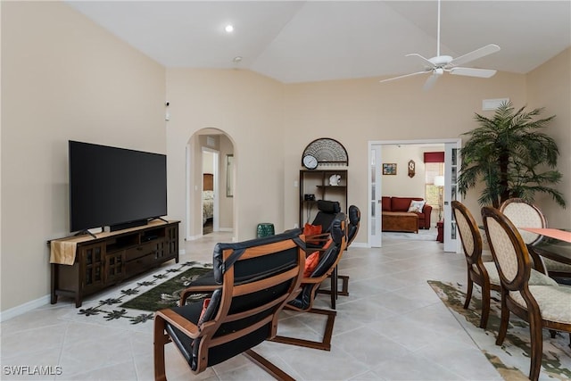 living room featuring ceiling fan, light tile patterned floors, and high vaulted ceiling