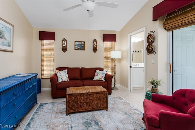 living room featuring vaulted ceiling, ceiling fan, a healthy amount of sunlight, and light tile patterned flooring