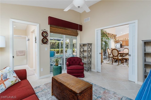 living room featuring light tile patterned floors, vaulted ceiling, and ceiling fan