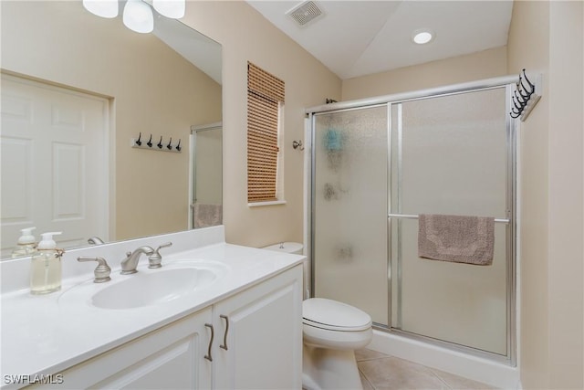 bathroom with tile patterned flooring, vanity, toilet, and walk in shower